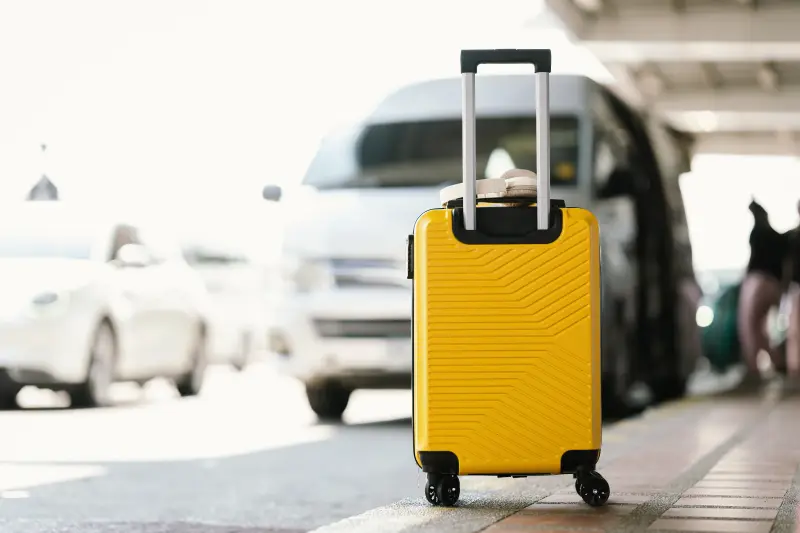 suitcase sitting at an airport pick-up area